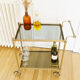 Glass and gold metal wheeled serving table 1960