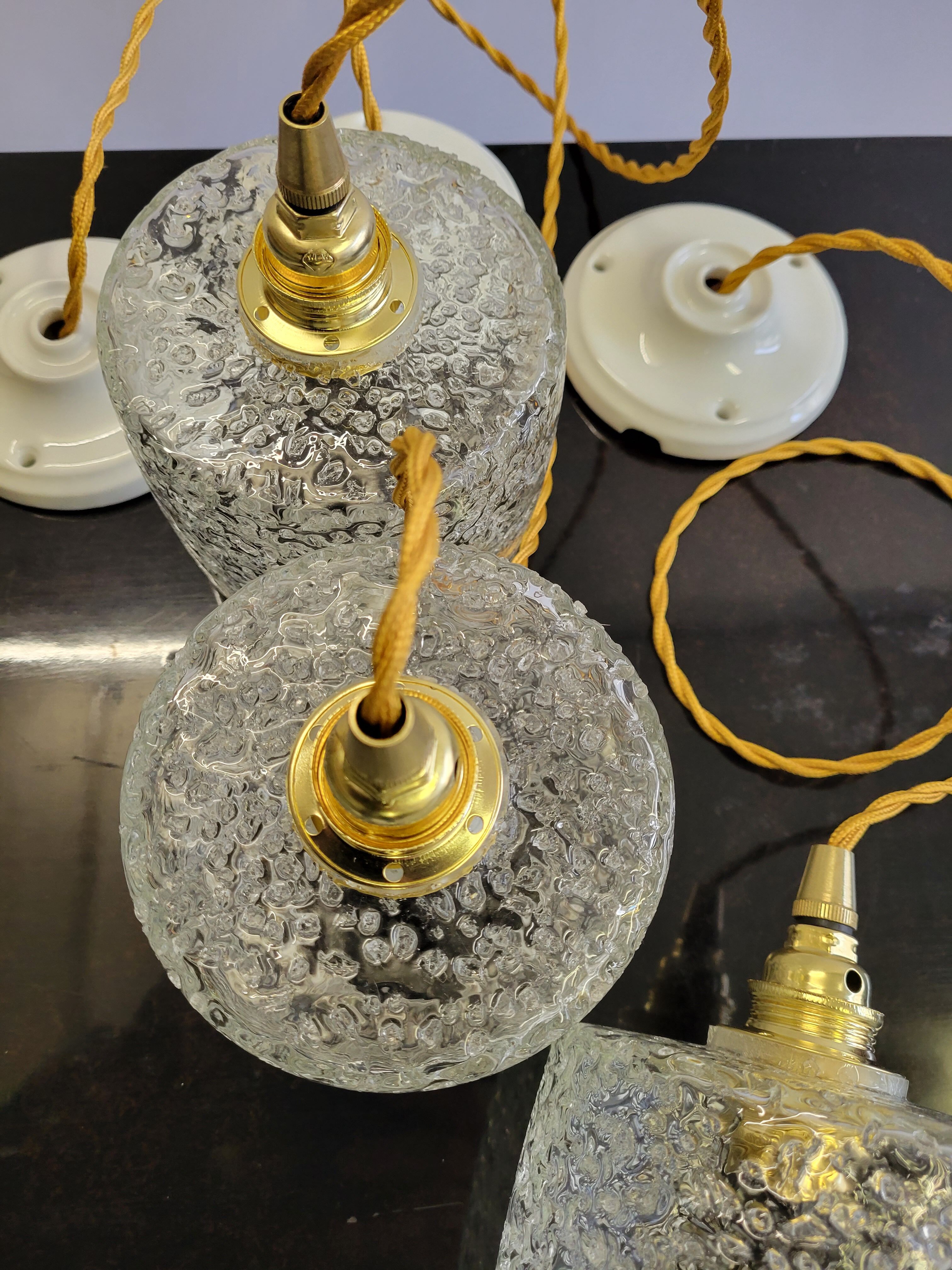 Trio of scrambled glass pendant lamps