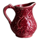 Red ceramic milk jug