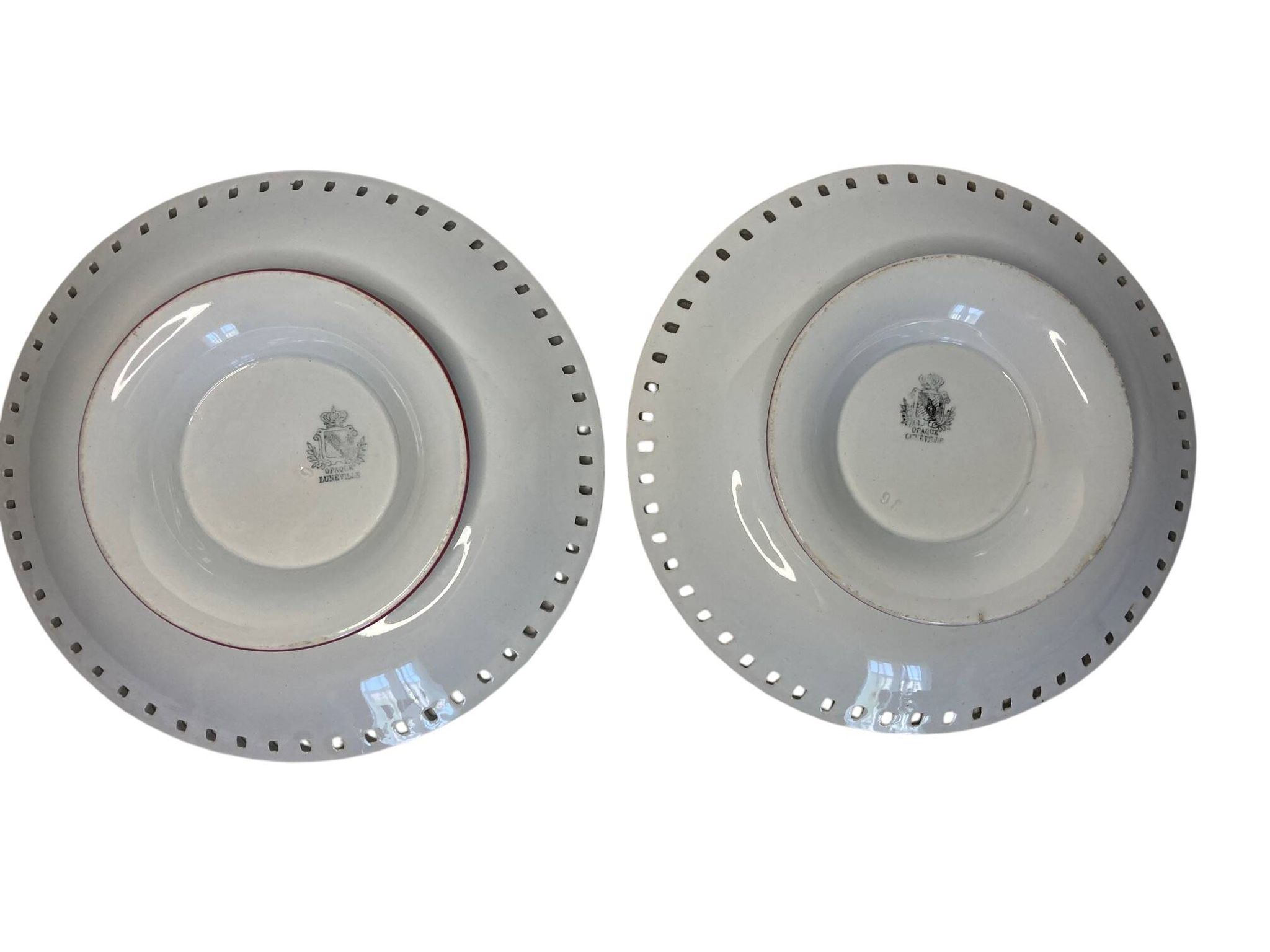 Lunéville, two floral earthenware bowls with pierced edges from the early 20th century.