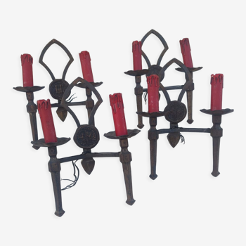 Two pairs of wrought iron sconces in high period style and dating from the 50s