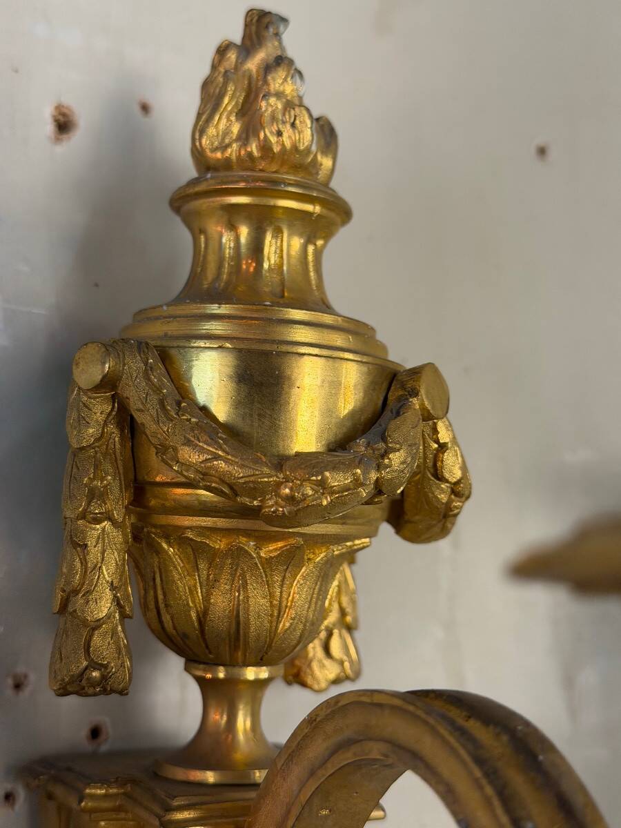 Pair of Louis XVI style wall sconces in gilded bronze, circa 1880.