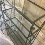 Pair of wrought iron and glass bookshelf shelves.