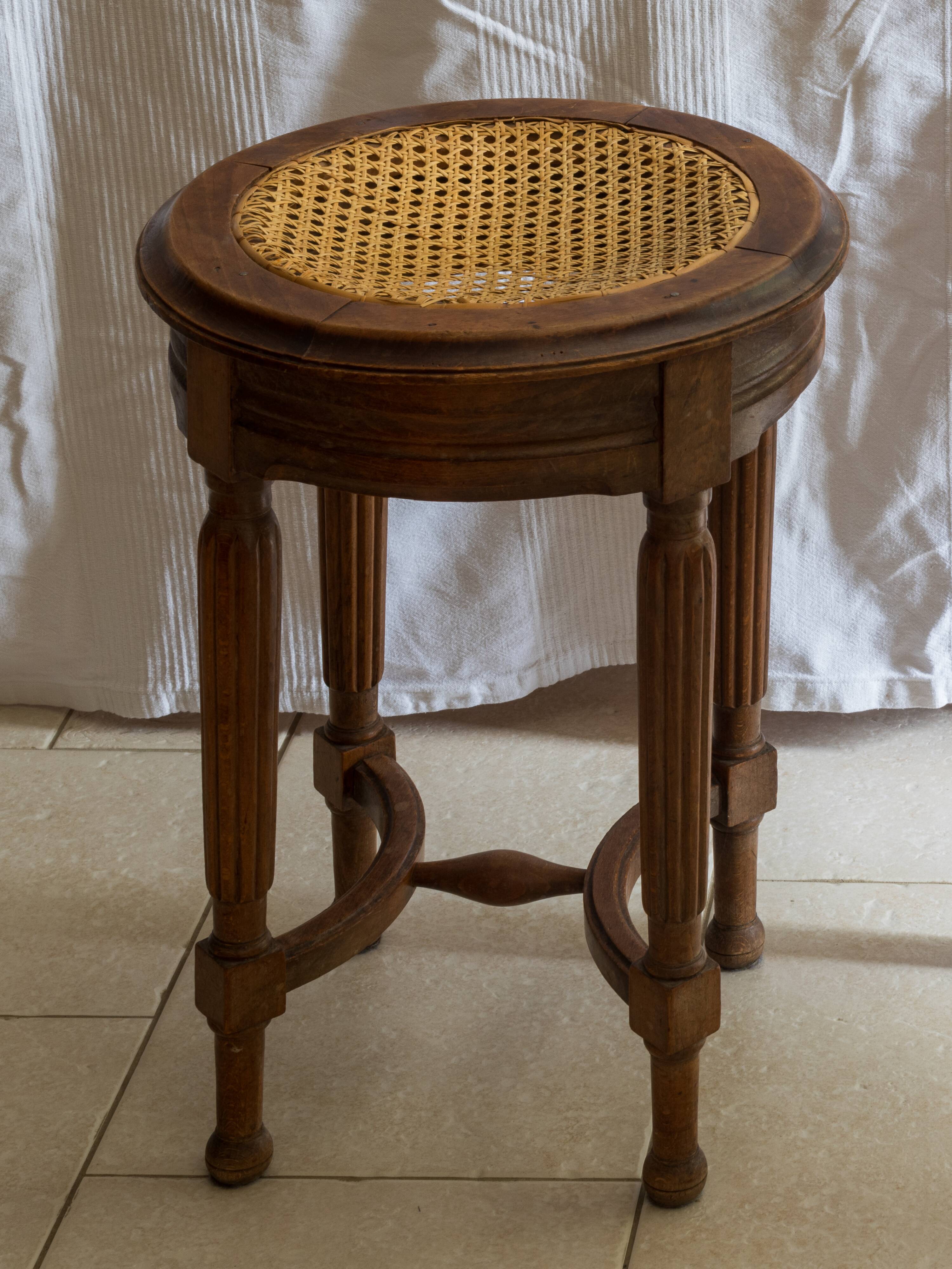 Antique armchair and stool with caned seat and fluted legs