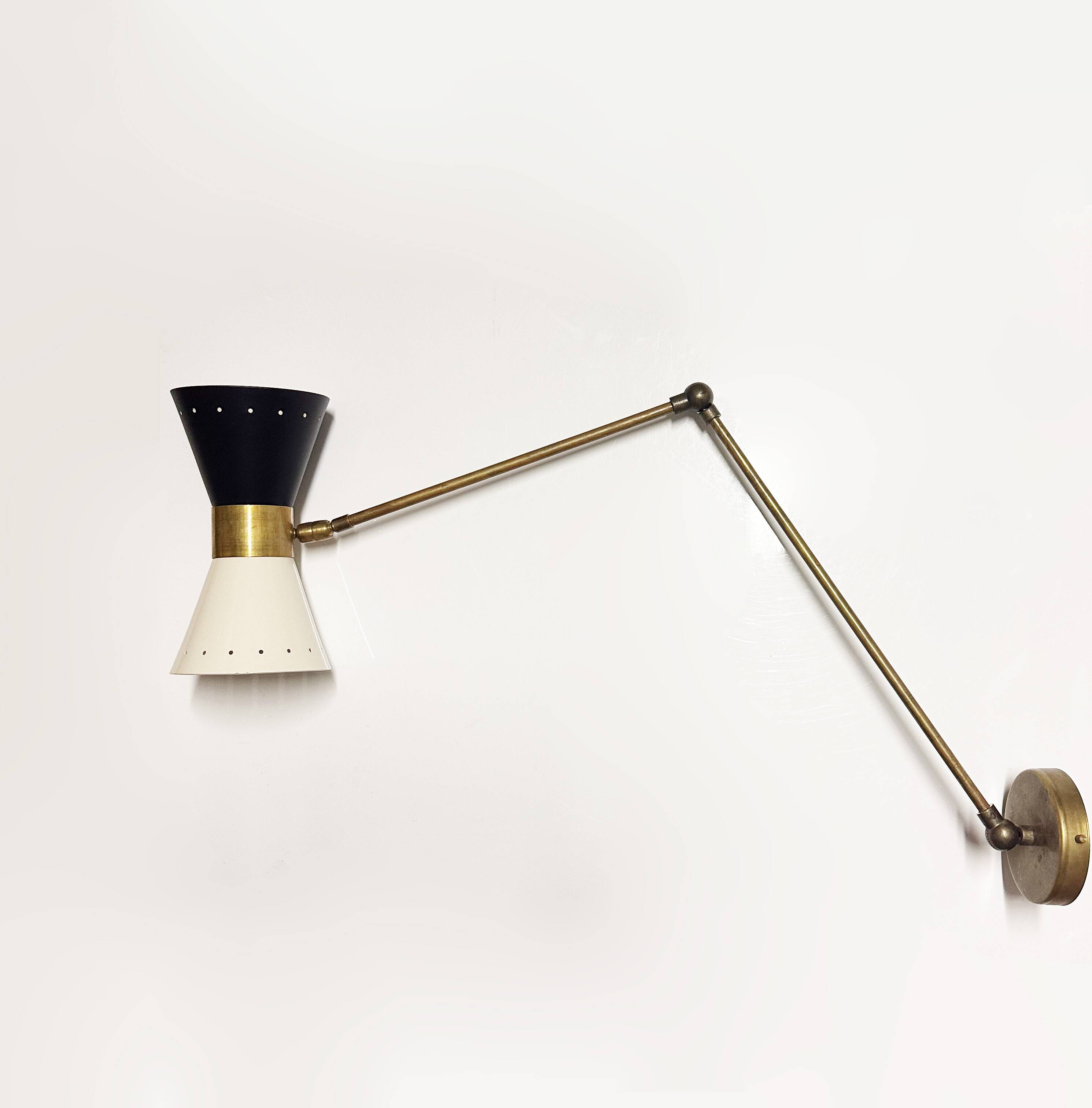 Articulated brass and lacquered iron wall light, 1950s design.