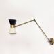 Articulated brass and lacquered iron wall light, 1950s design.