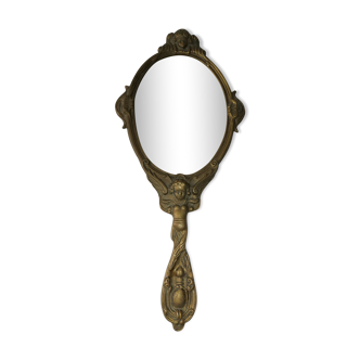 Old hand-facing mirror in gilded bronze