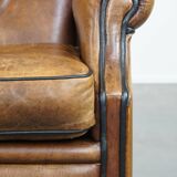 Sheep leather wingback chair finished with black piping