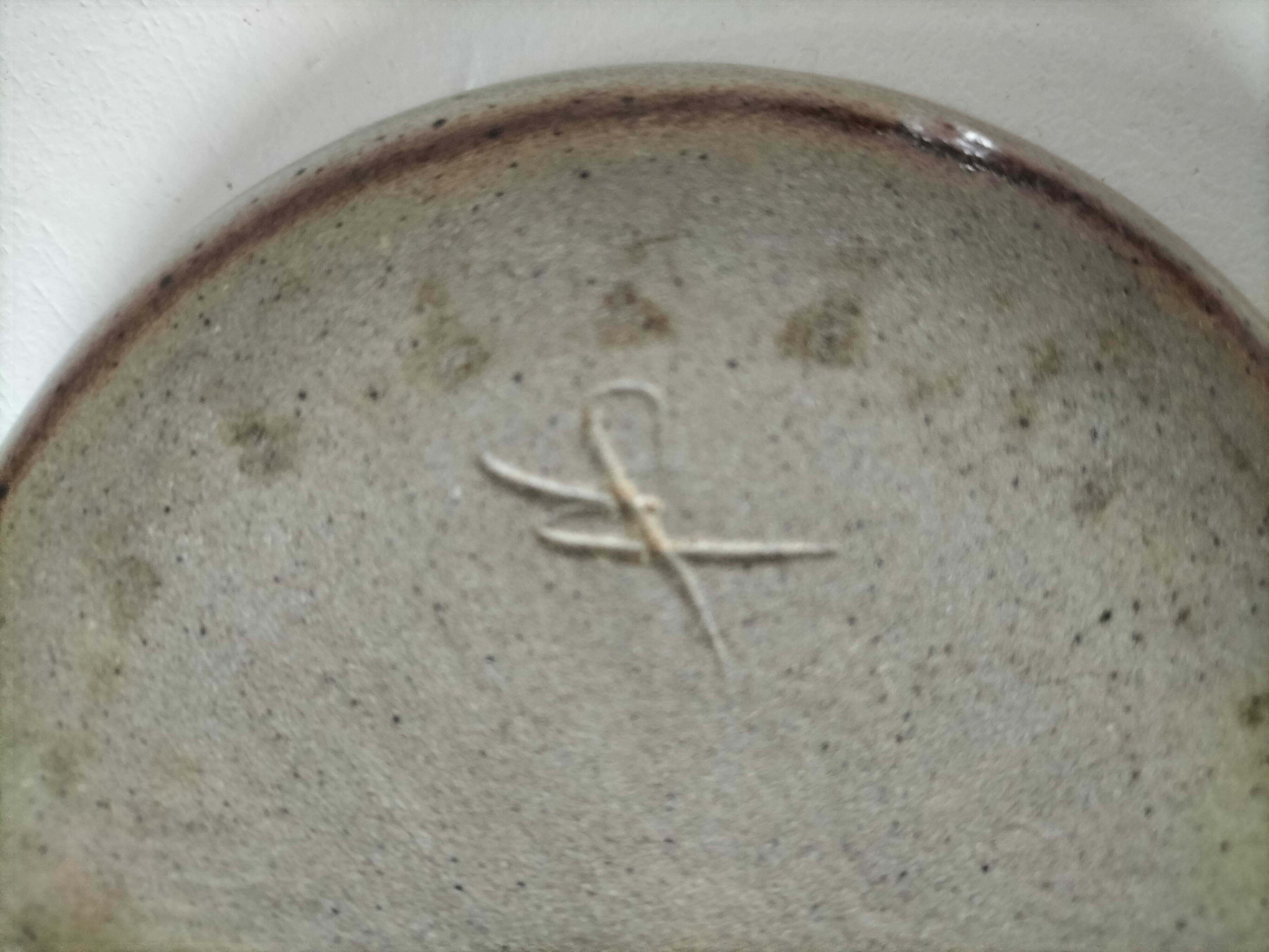 Signed stoneware bowl from Puisaye, relief decoration.