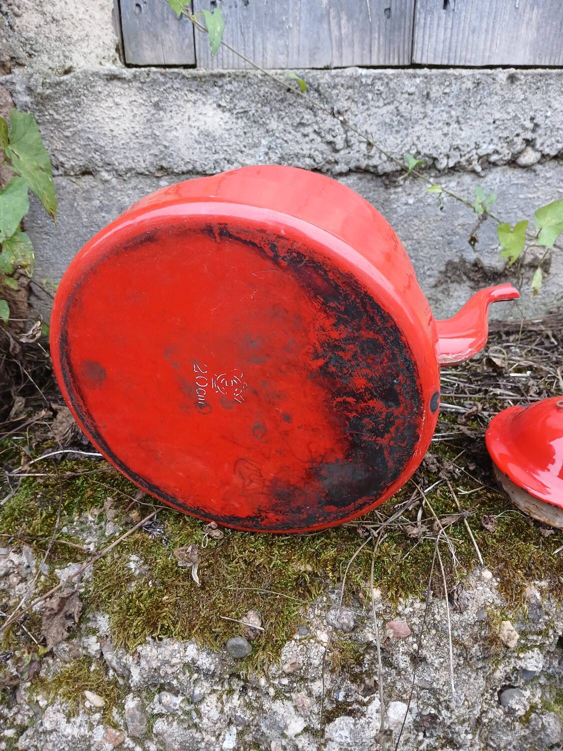 Antique teapot in red enamelled sheet metal