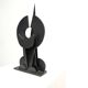 Black brutalist wooden sculpture