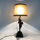 Old table lamp in repel, cherub, angel, cherub, putti with a bird in hand. 1930s