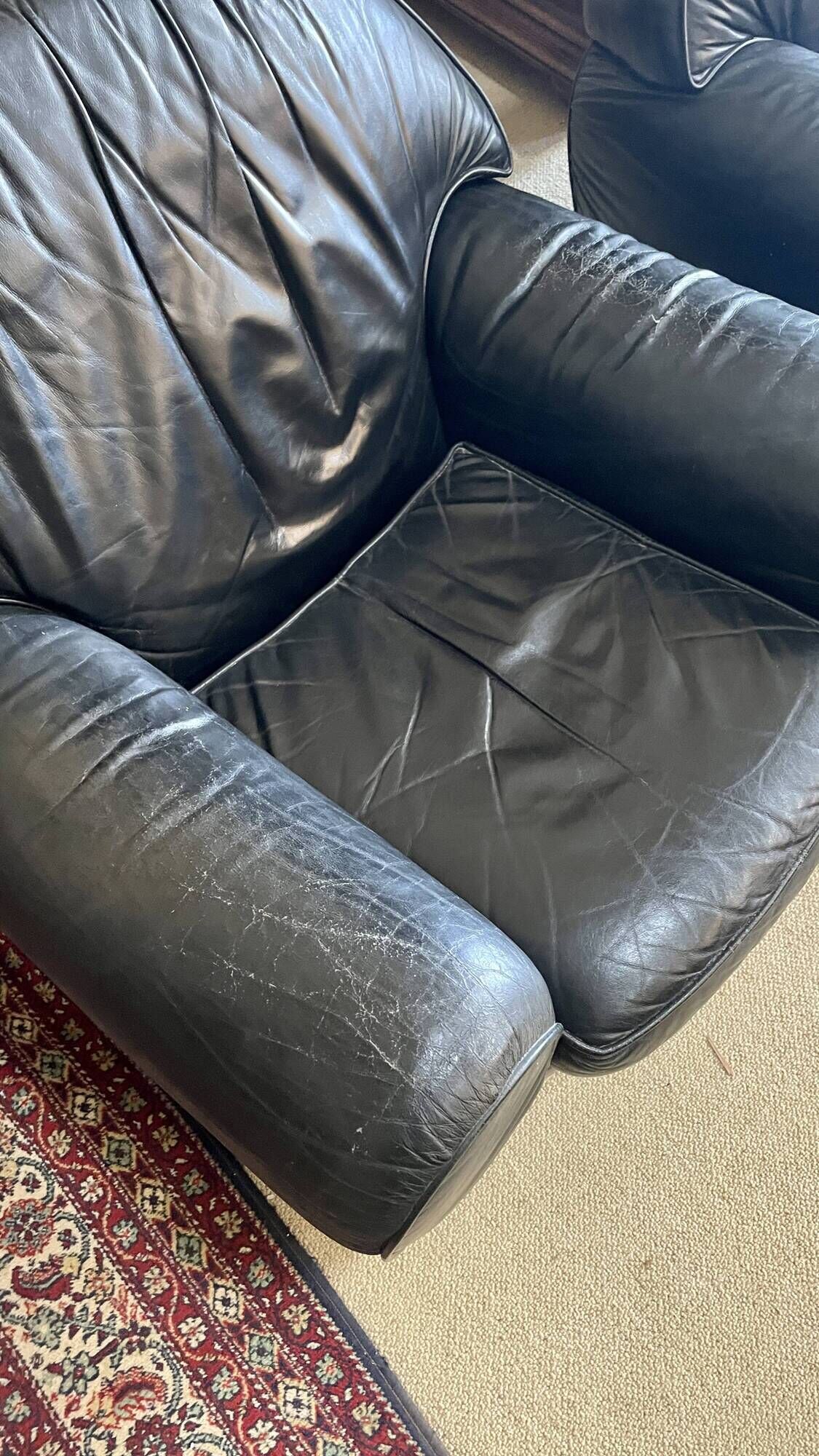 Pair of black leather club armchairs, twentieth century