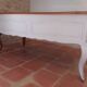 Solid wood desk with distressed white paint.