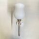 Pair of brass torch wall lights with white opal glass and porcelain