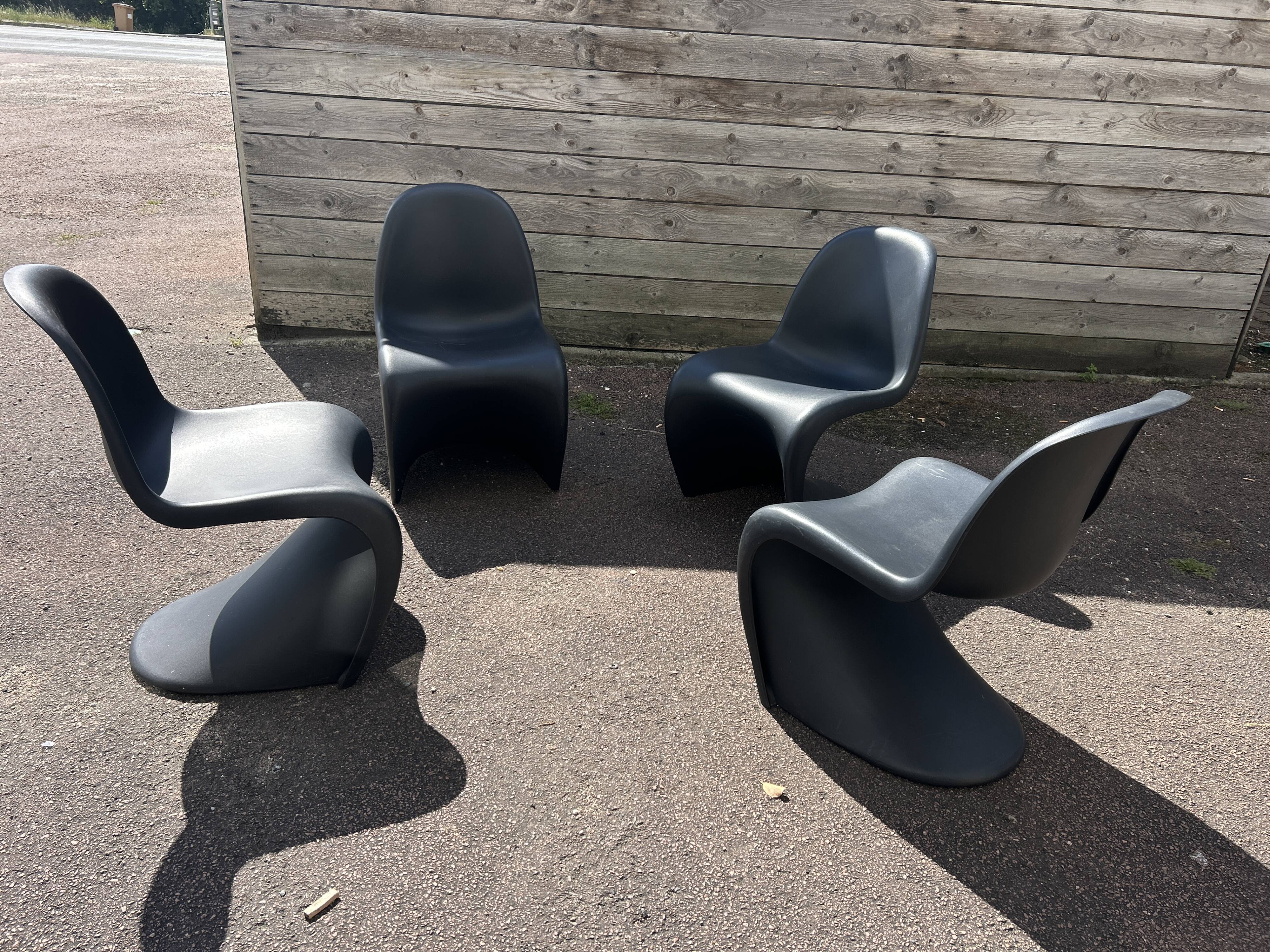 Set of 4 black Verner Panton Vitra chairs.