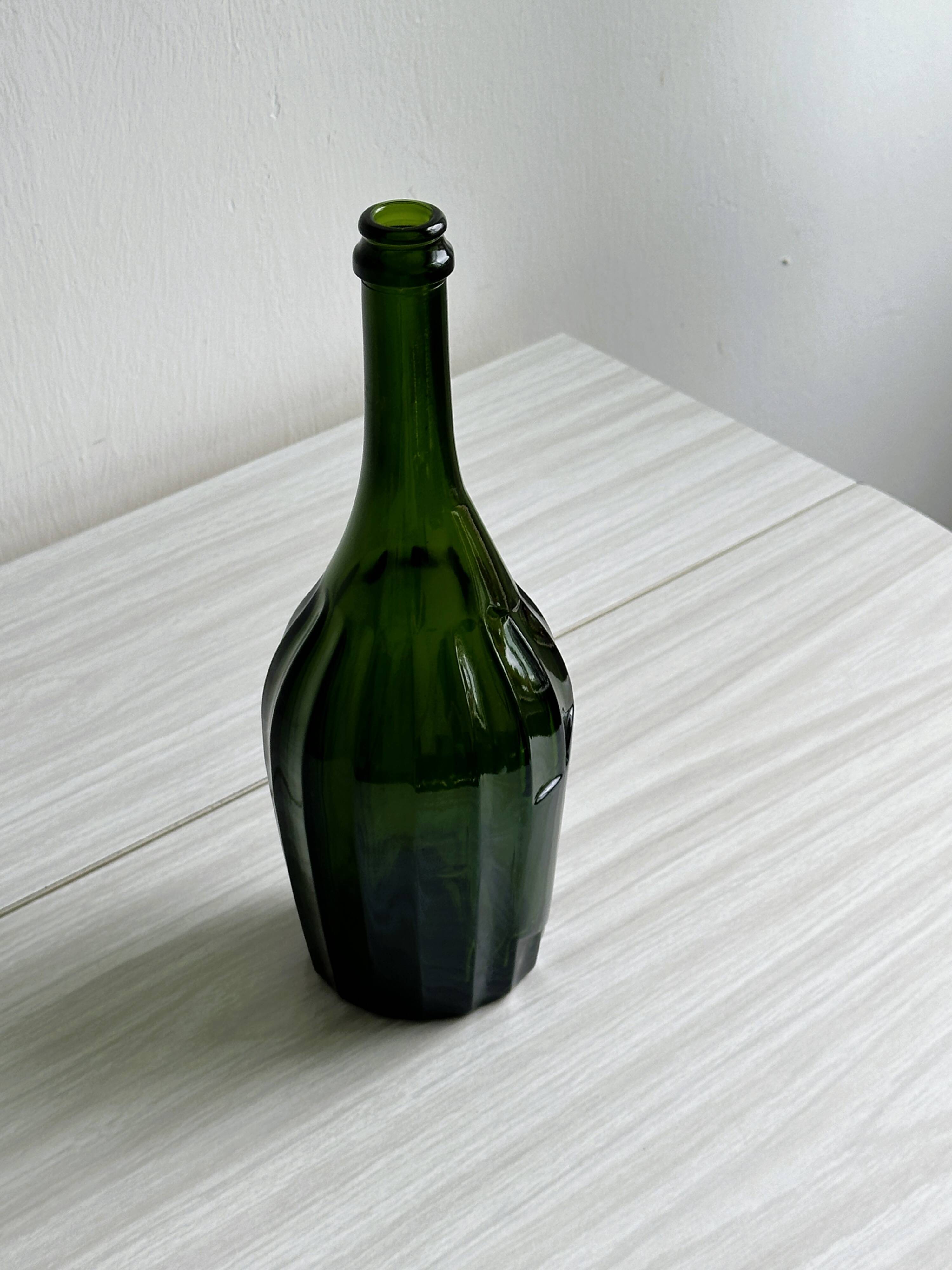 Translucent green glass bottle, classic design.