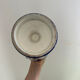 white amphora-style vase with hand-painted blue patterns