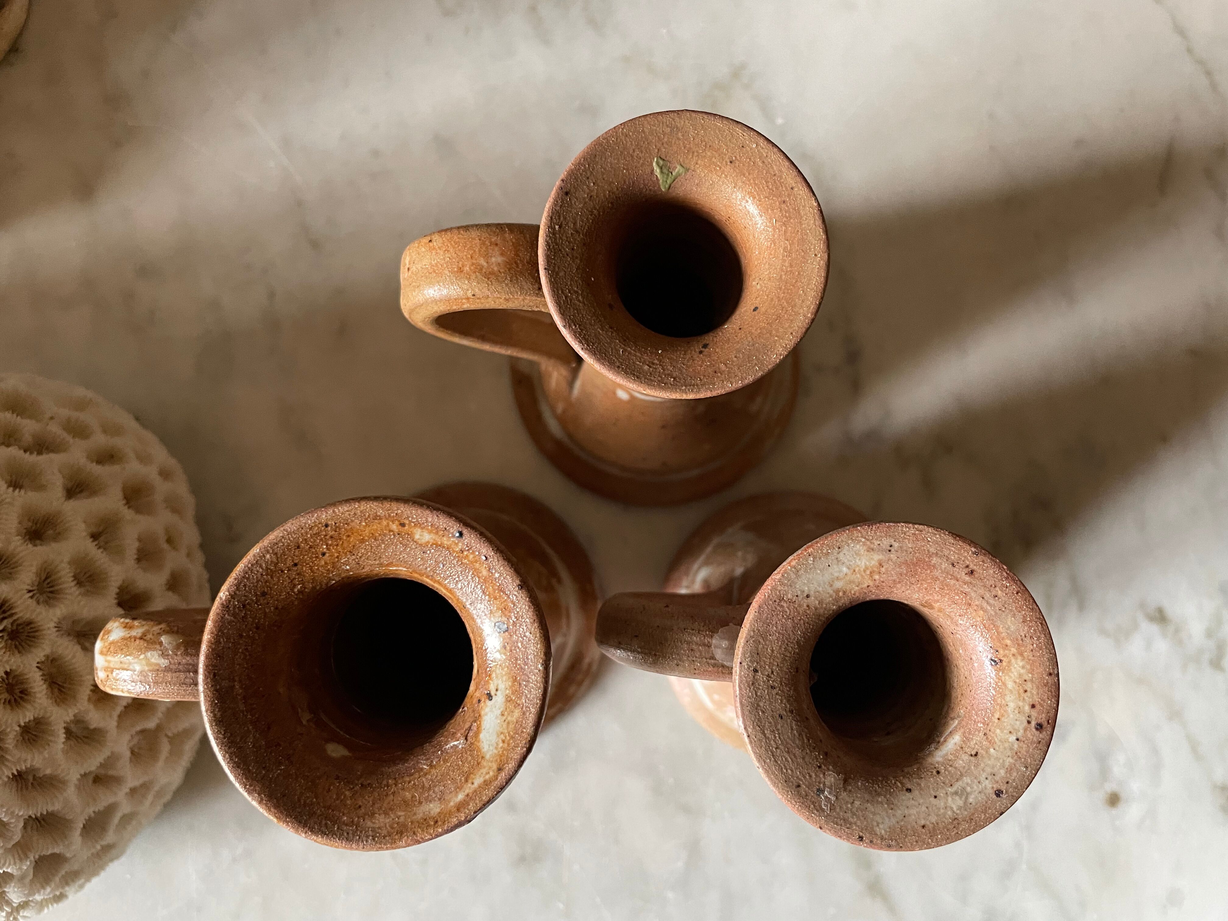 Trio of stoneware candle holders