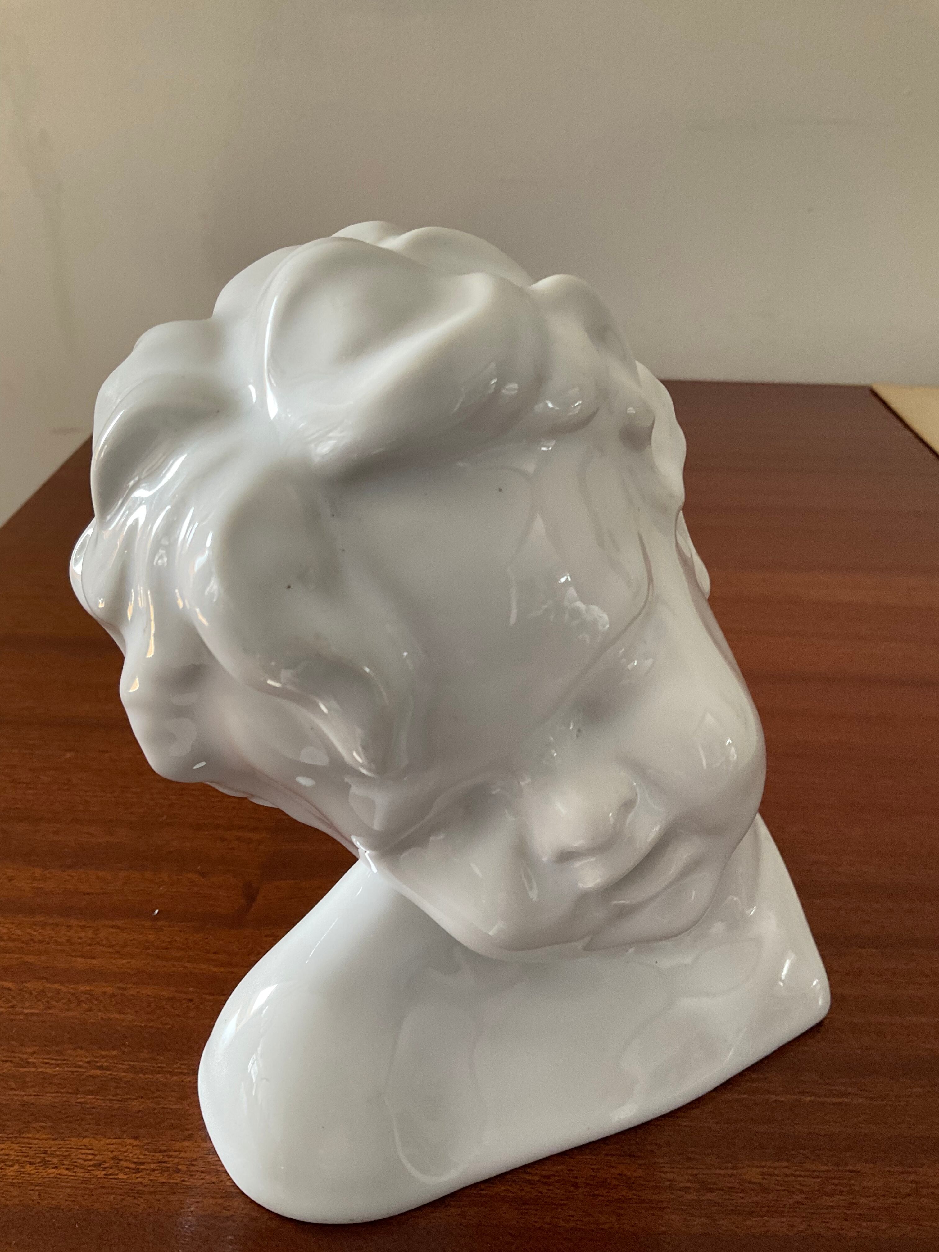 Cherub child bust in enamelled porcelain