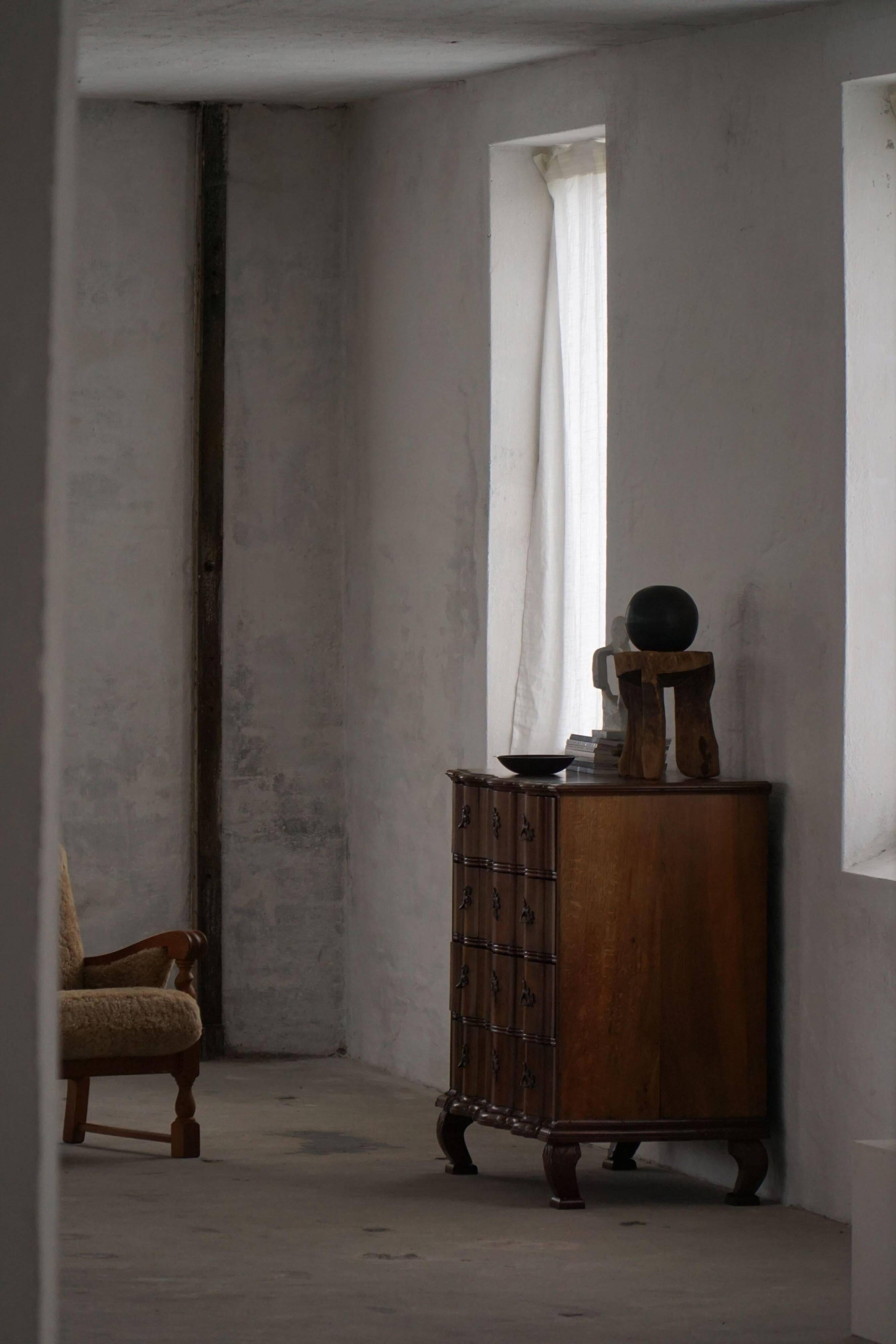 Antique baroque oak commode from the late 18th century with cabriole legs.