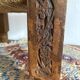 Low stool with carved wood and braided cord.