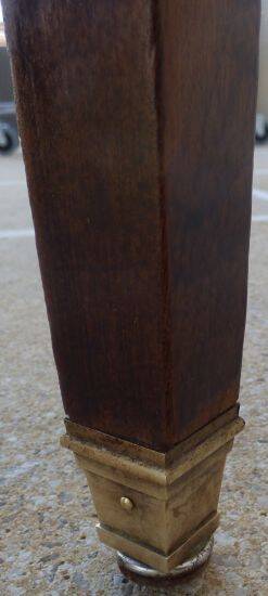 Round mahogany table with mahogany veneer and brass sabot foot.