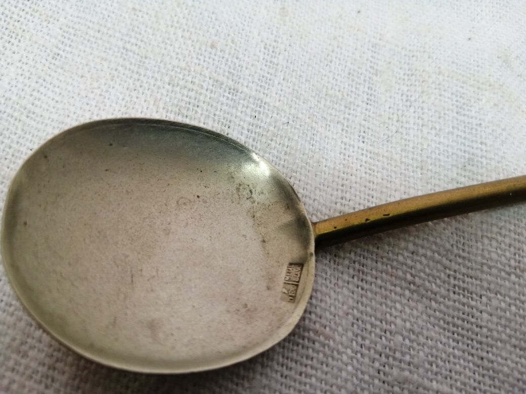 Ancient silver metal spoon and vintage brass
