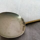 Ancient silver metal spoon and vintage brass