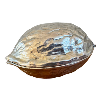 Silver metal nutcracker in the shape of a walnut