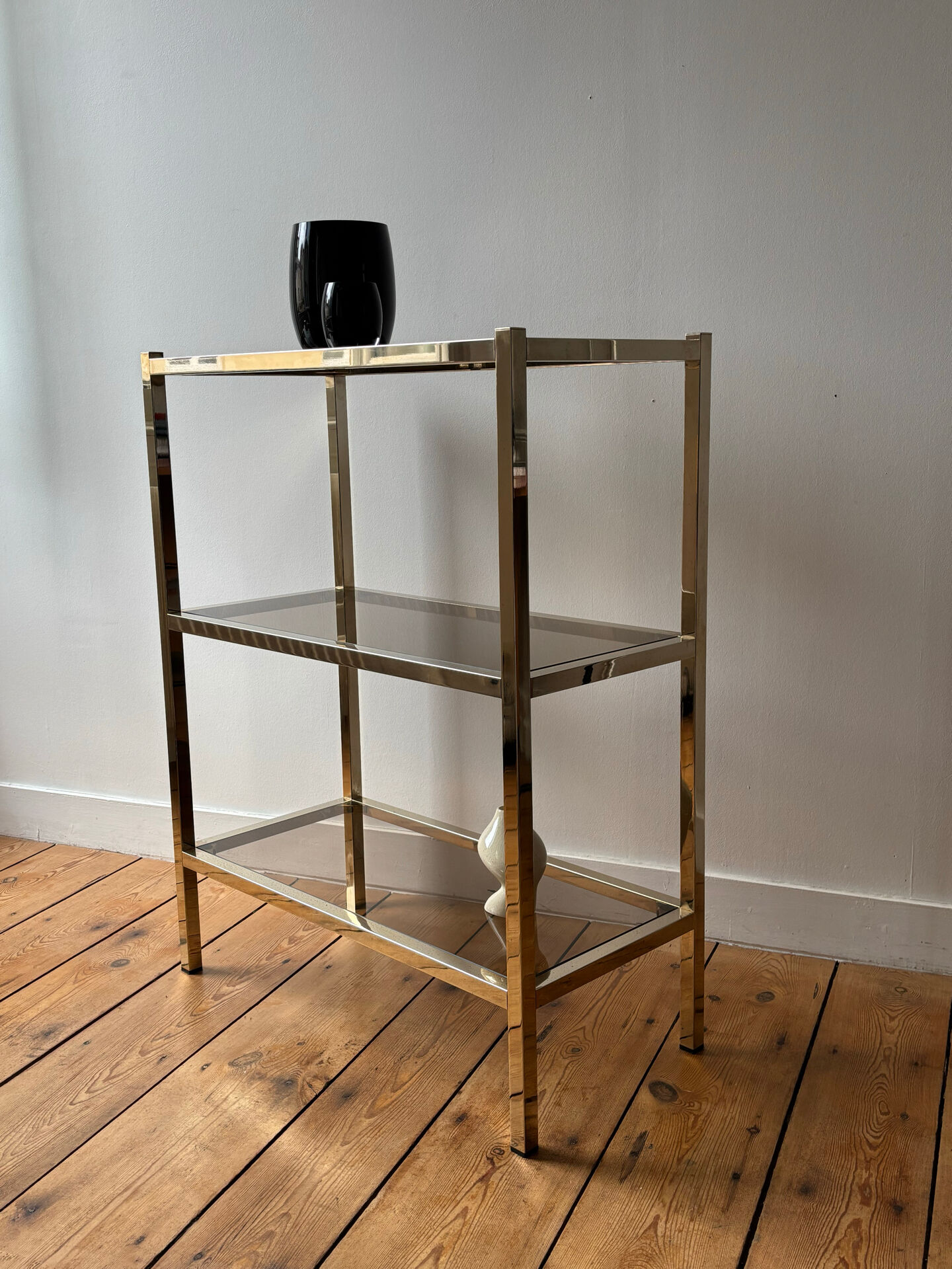 Brass and smoked glass library shelves