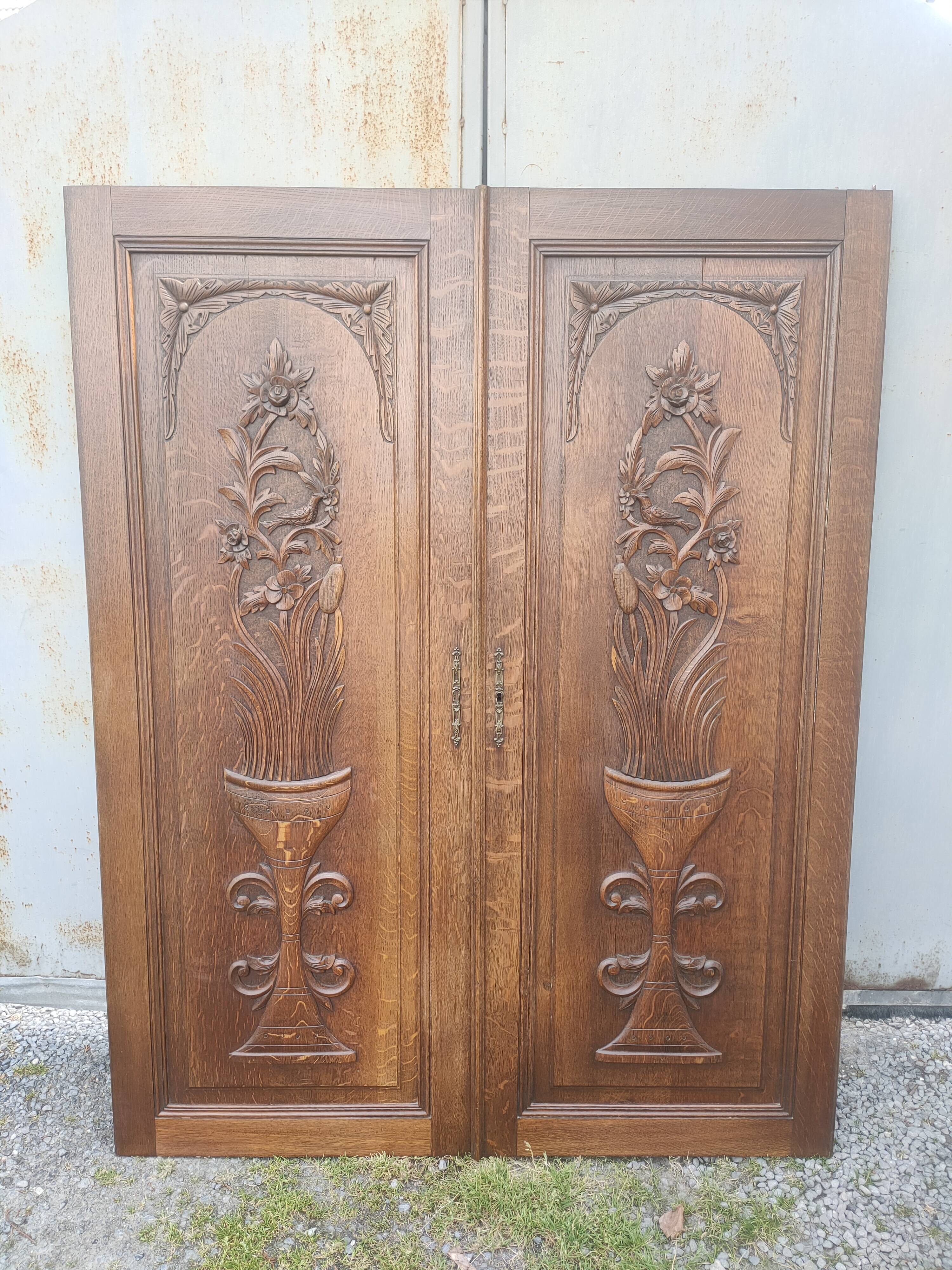 pair of antique solid oak cabinet doors with bird decor