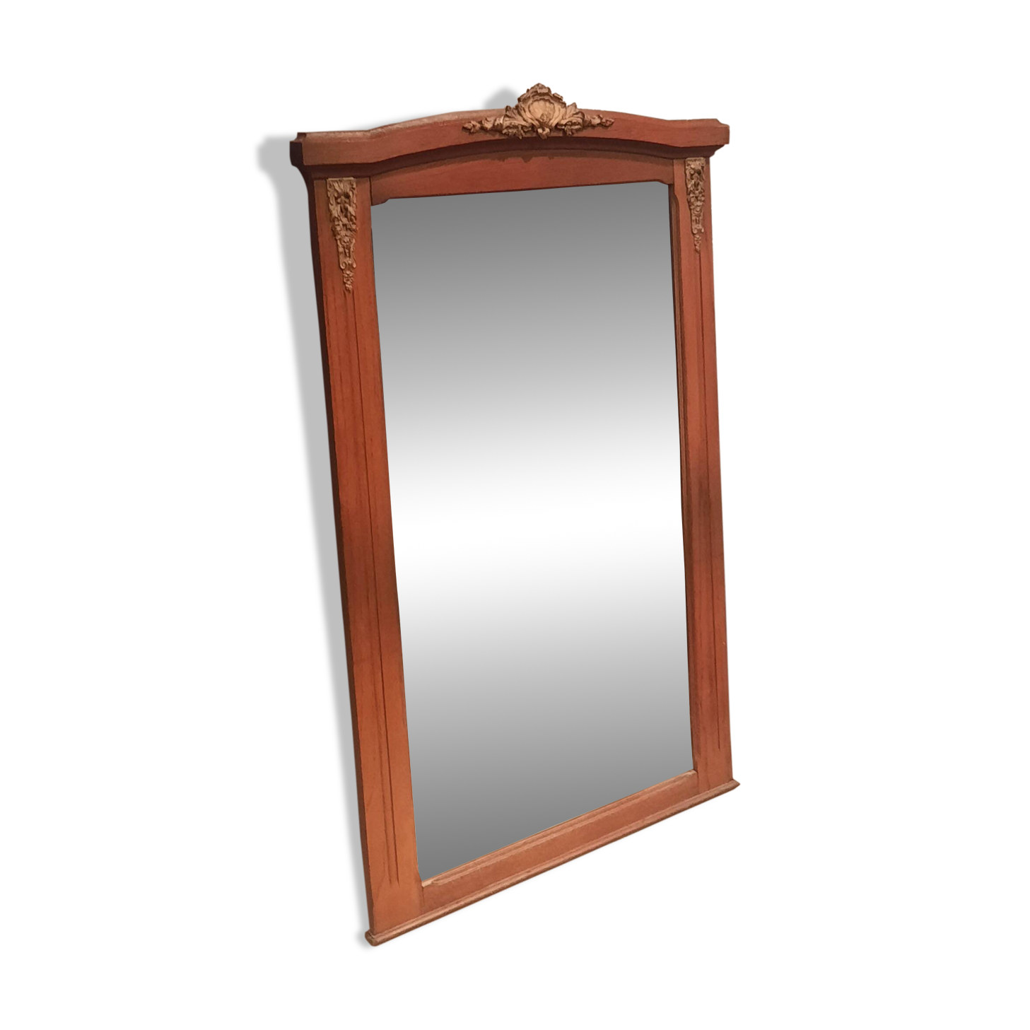 Bevelled mirror surrounded by a wooden frame.