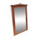Bevelled mirror surrounded by a wooden frame.