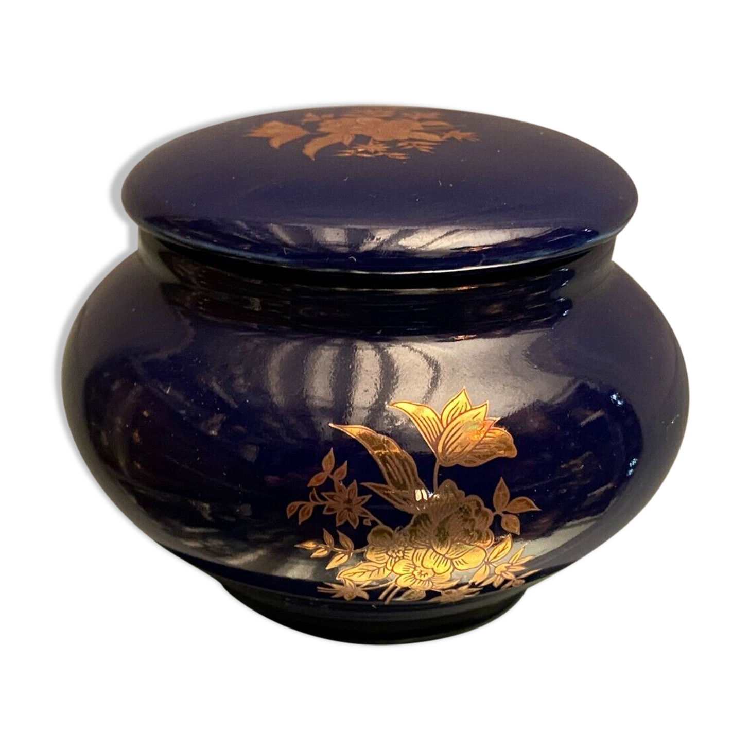 Porcelain candy box with golden floral decoration on a midnight blue background