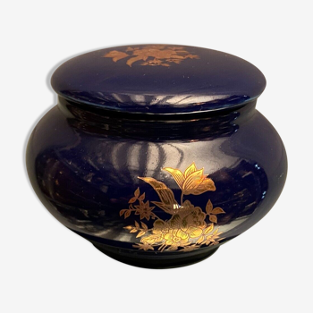 Porcelain candy box with golden floral decoration on a midnight blue background