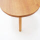 Vintage solid wood side table with rounded legs.
