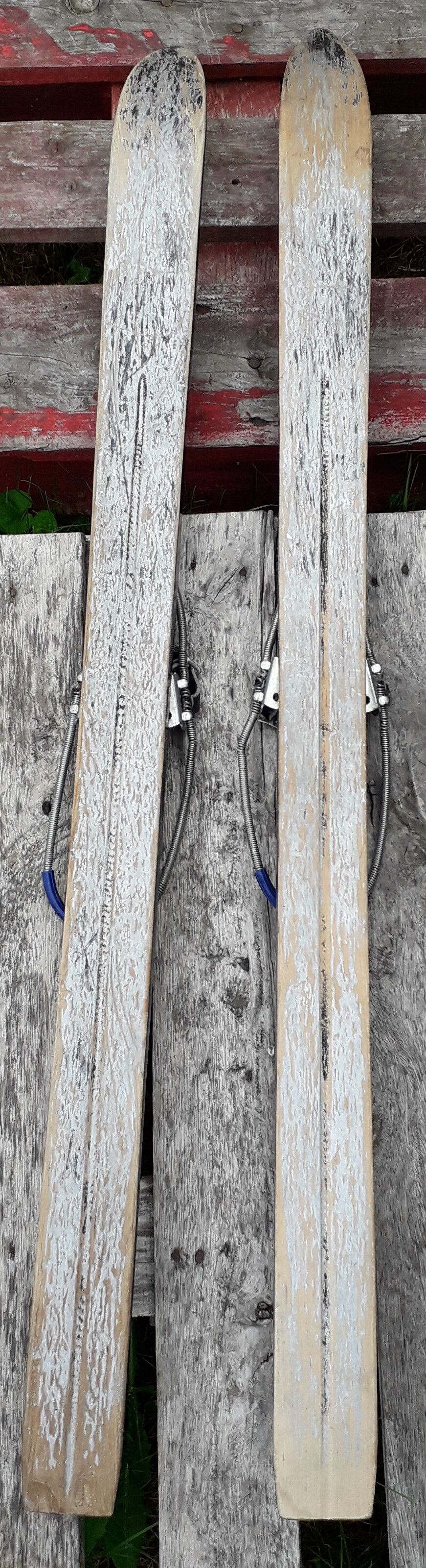Pair of old children ski ings in blue wood