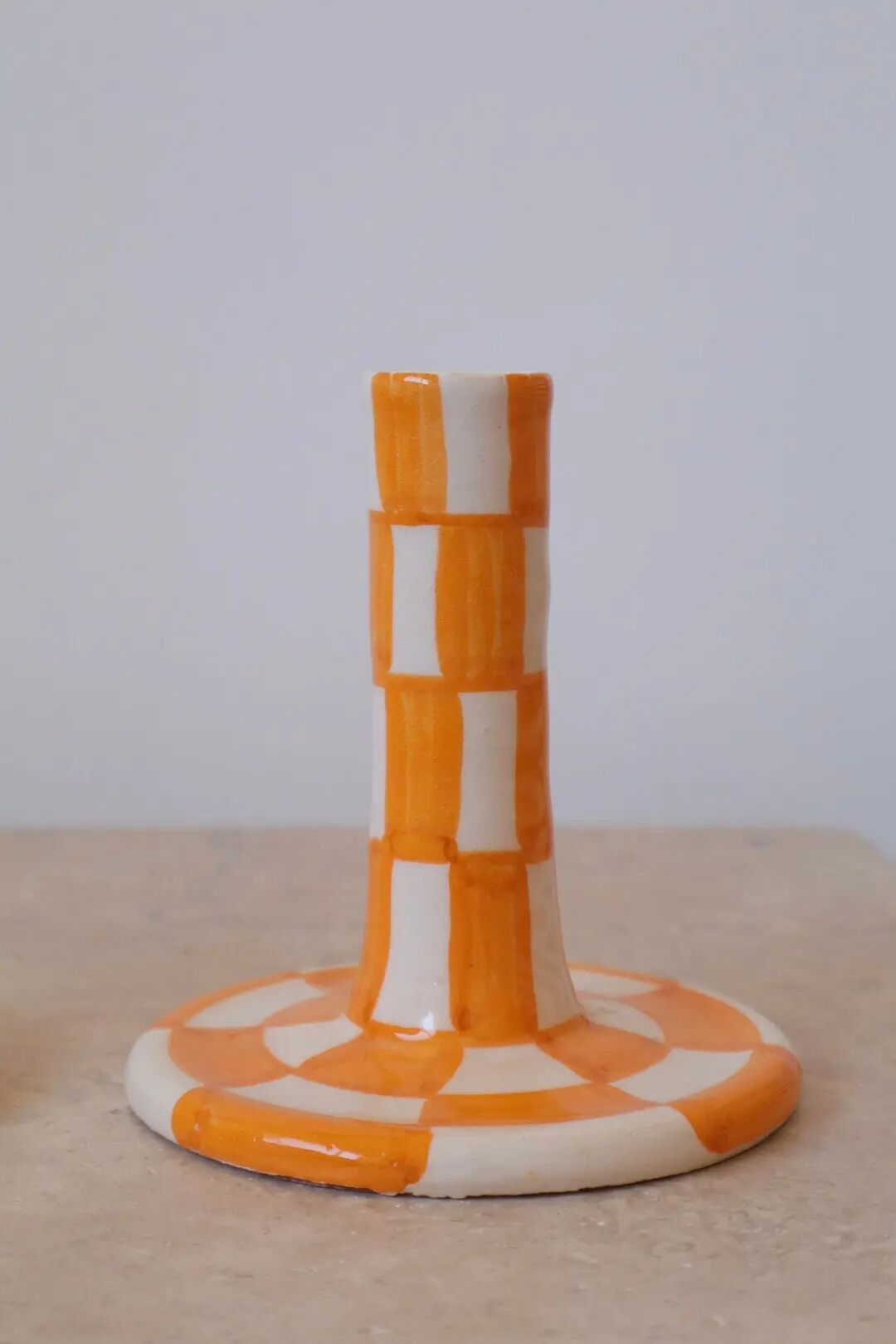 Pair of yellow and white checkered ceramic candlesticks