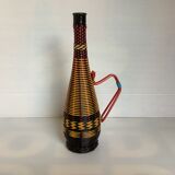 Old bottle in yellow, red and black scoubidou