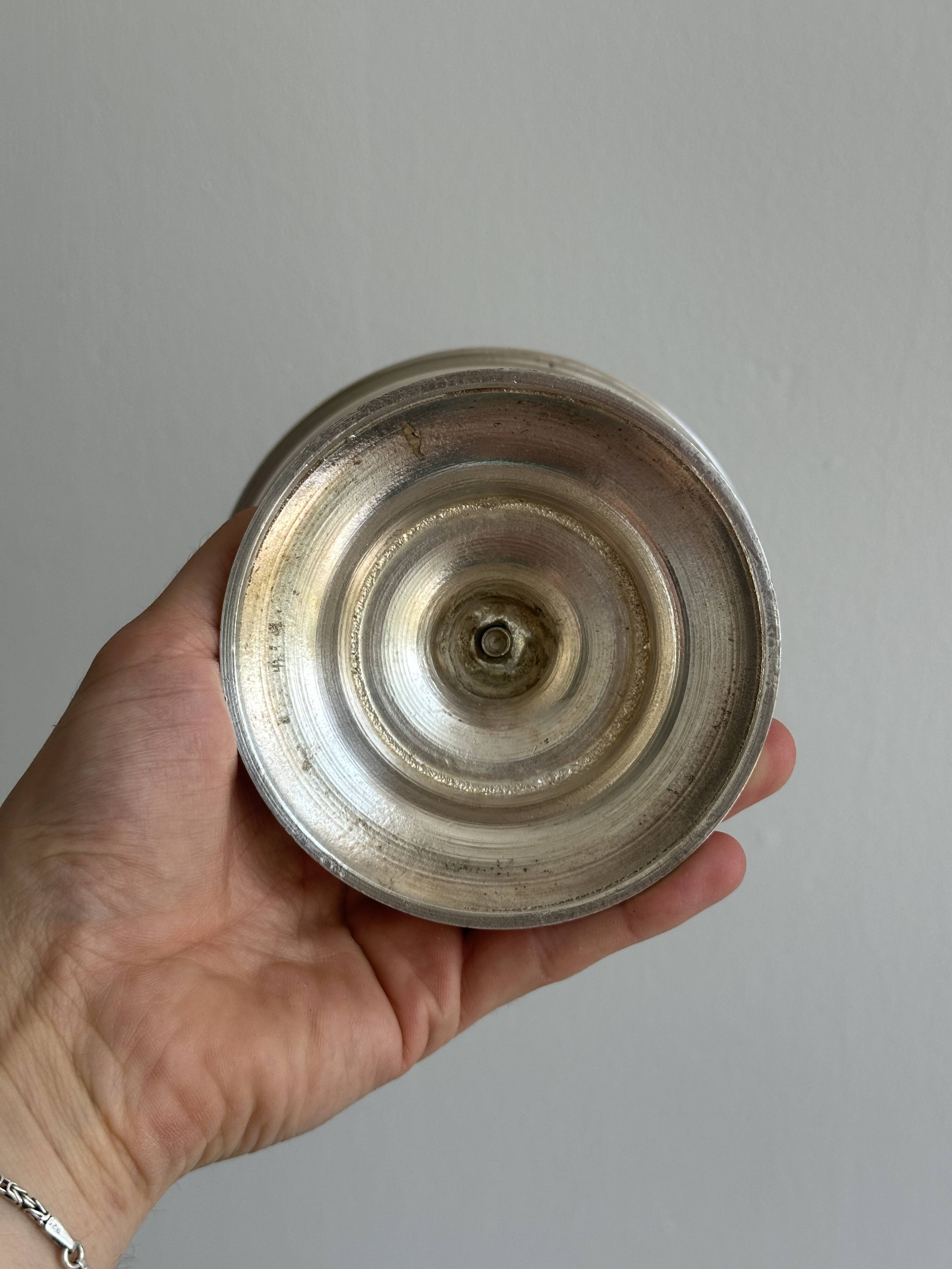 Silver-plated metal stand.