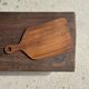 Rectangular solid teak chopping board with elongated handle 30x16.