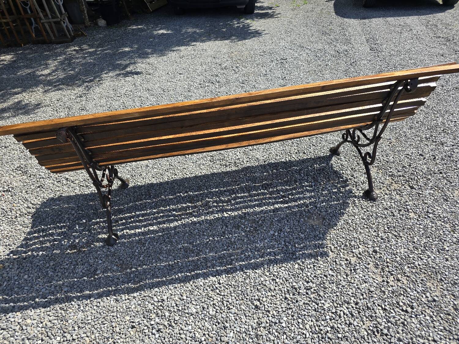Wooden garden bench with cast iron base