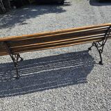 Wooden garden bench with cast iron base