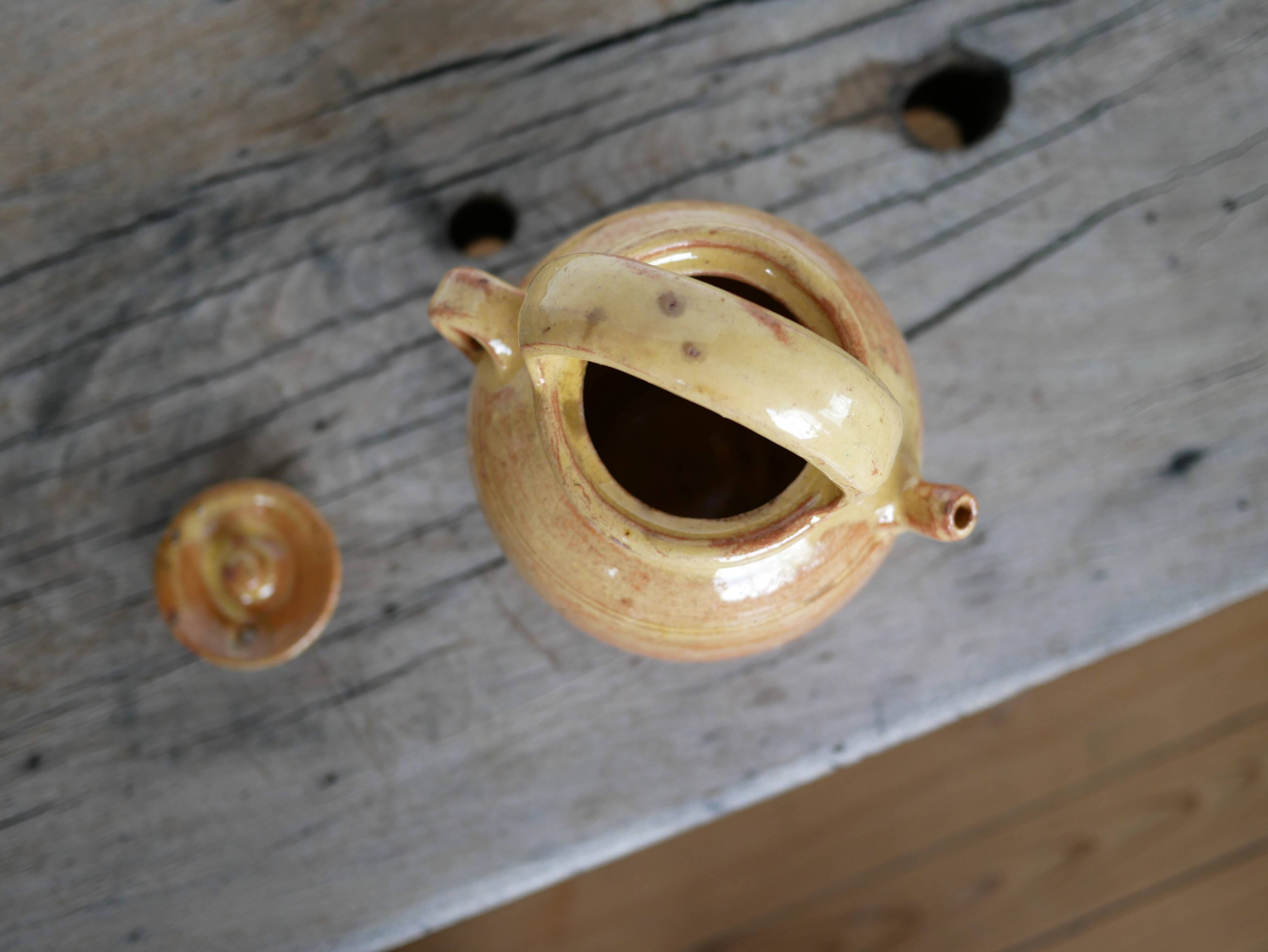 Old gargoulette pot in glazed terracotta