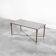 Patinated brass and glass coffee table by Maison Charles from the 1960s.