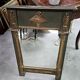 Empire-style mirror in deep green lacquered wood richly enhanced.
