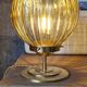 Globe table lamp in amber chiseled glass