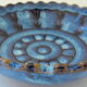 Cut or pocket in polychrome varnished sandstone with a blue and floral decoration