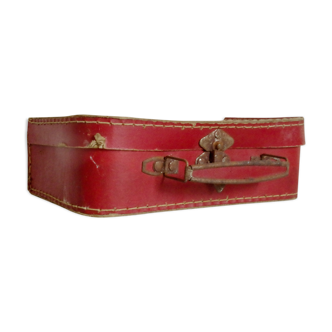 Small old red suitcase